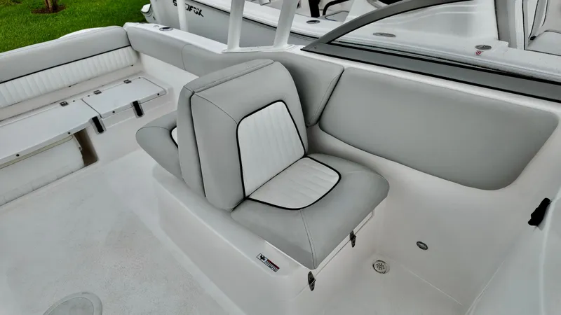 Slide: The Image of 2023 Sea Fox 226 Traveler boat interior with cushioned seating and sleek design. - 23