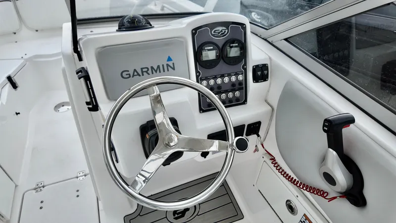 Slide: The Image of 2023 Sea Fox 226 Traveler boat dashboard with Garmin navigation system and steering wheel. - 25