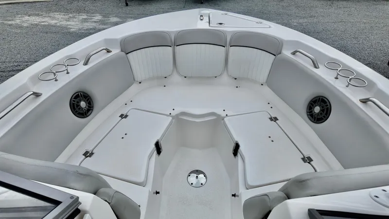 Slide: The Image of 2023 Sea Fox 226 Traveler boat interior with seating, cup holders, and storage compartments. - 7
