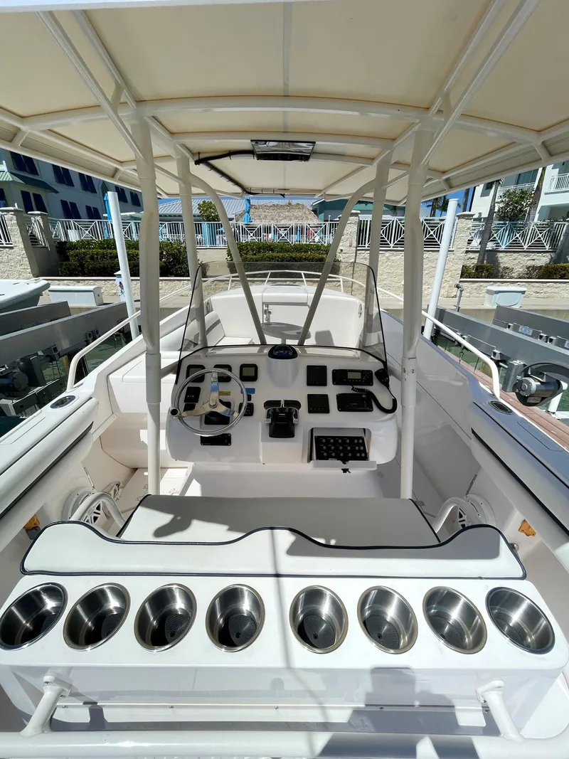 Slide: The Image of 2008 Intrepid 323 Cuddy boat interior with helm, seating, and cup holders. - 3