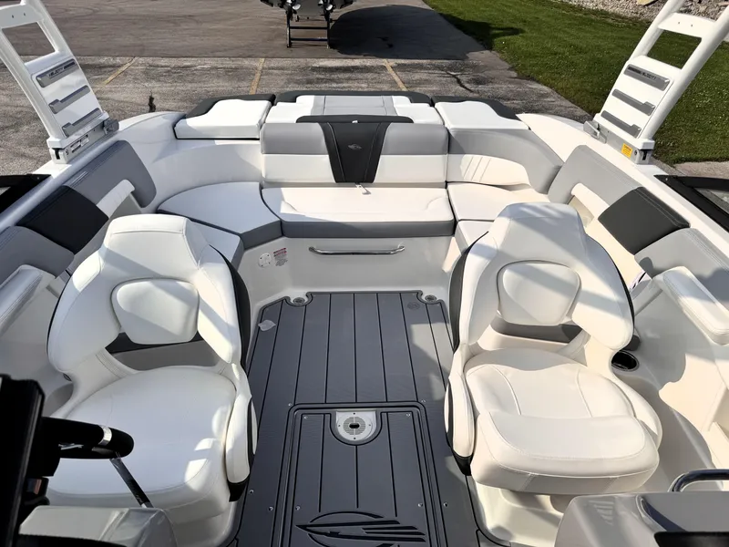 Slide: The Image of 2025 Chaparral 23 SSi boat interior with white seating and sleek design. - 12