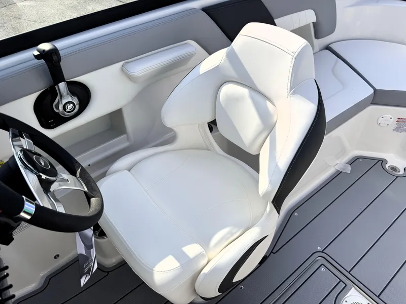 Slide: The Image of 2025 Chaparral 23 SSi boat interior with white captain's chair and steering wheel. - 17