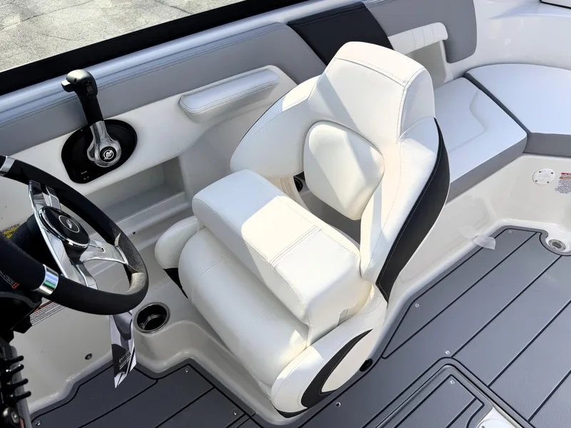 Slide: The Image of 2025 Chaparral 23 SSi boat interior with white captain's seat and steering wheel. - 18
