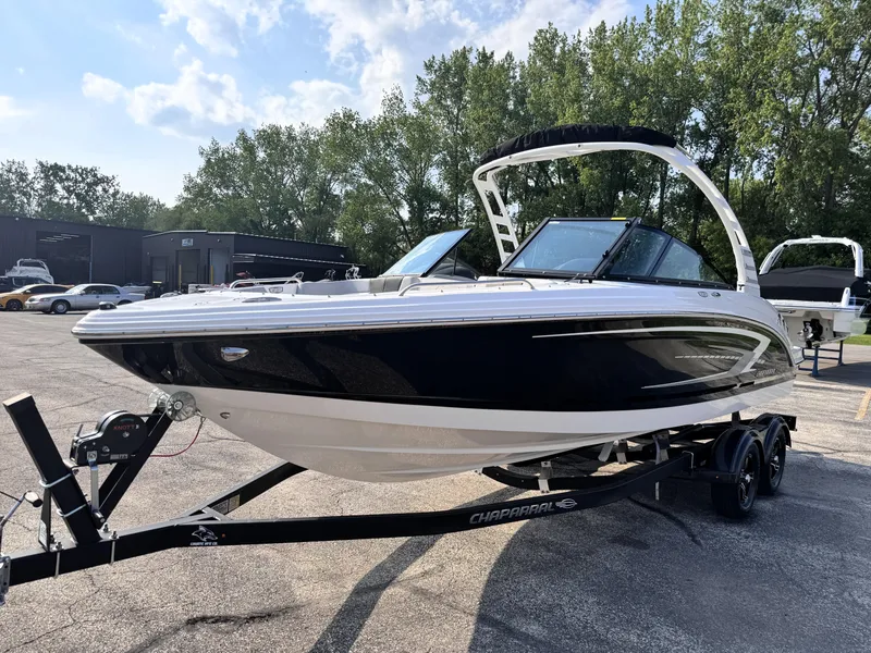 Slide: The Image of 2025 Chaparral 23 SSi boat on trailer, sleek design, parked outdoors. - 2