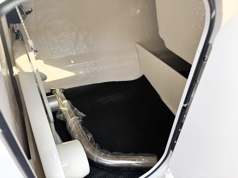 Slide: The Image of Interior storage compartment of 2025 Chaparral 23 SSi boat, featuring sleek design. - 22