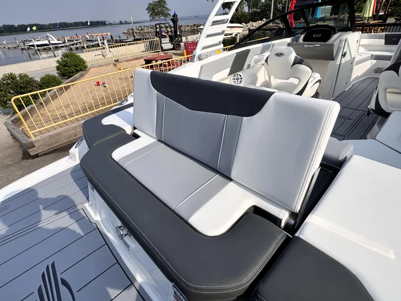 Slide: The Image of 2025 Chaparral 23 SSi boat interior with sleek seating and modern design by the waterfront. - 25