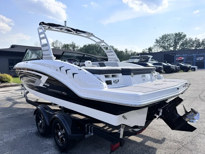 Slide: The Image of 2025 Chaparral 23 SSi boat on trailer, sleek design, black and white color scheme. - 3