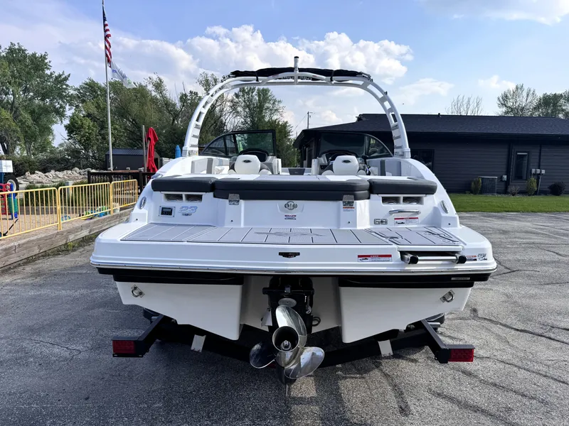 Slide: The Image of 2025 Chaparral 23 SSi boat, rear view, parked outdoors on a sunny day. - 4