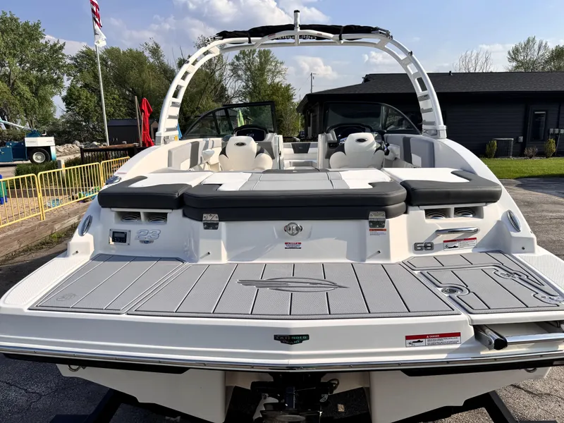 Slide: The Image of 2025 Chaparral 23 SSi boat, rear view, showcasing spacious deck and seating. - 5