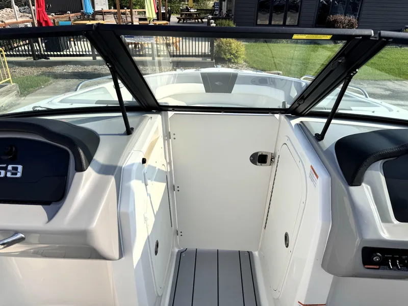 Slide: The Image of 2025 Chaparral 23 SSi boat interior with sleek design and modern dashboard. - 8