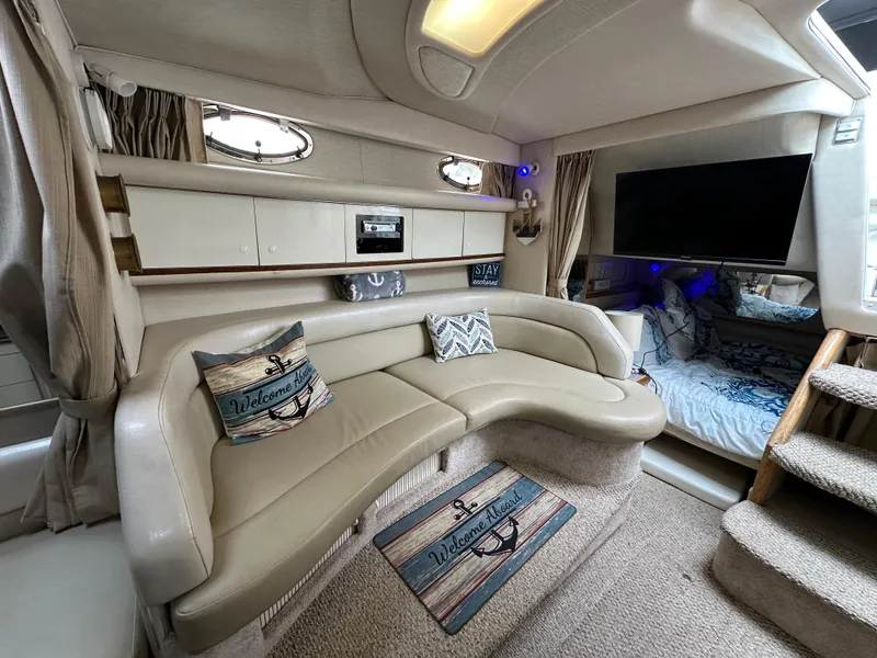 Slide: The Image of Interior of 1996 Sea Ray 330 Sundancer with beige seating and nautical decor. - 12