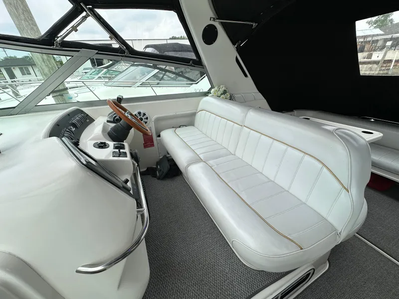 Slide: The Image of 1996 Sea Ray 330 Sundancer cockpit with white seating and steering wheel. - 7