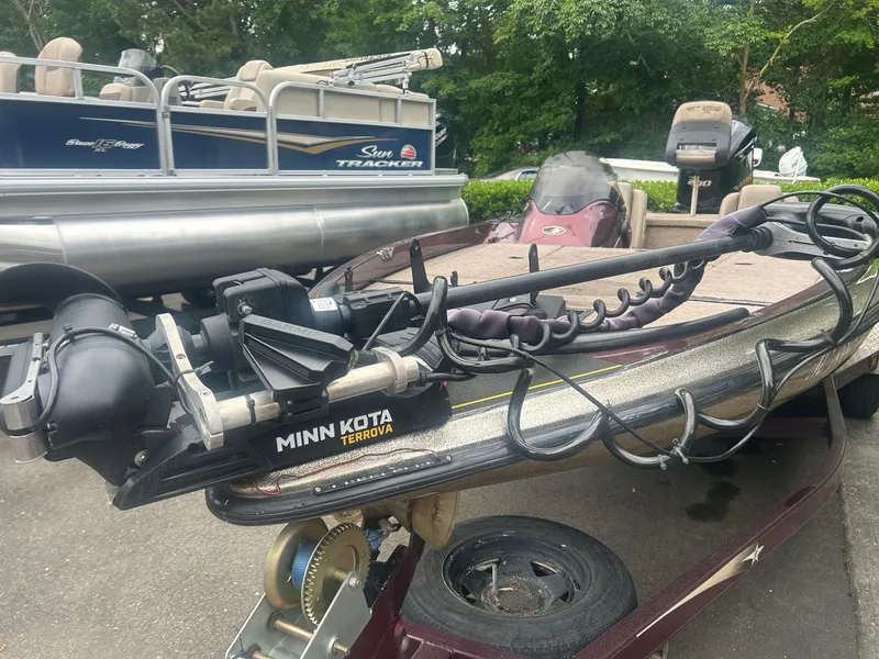 Slide: The Image of 2000 Stratos 21 SS Extreme boat with Minn Kota Terrova motor, parked on trailer. - 2