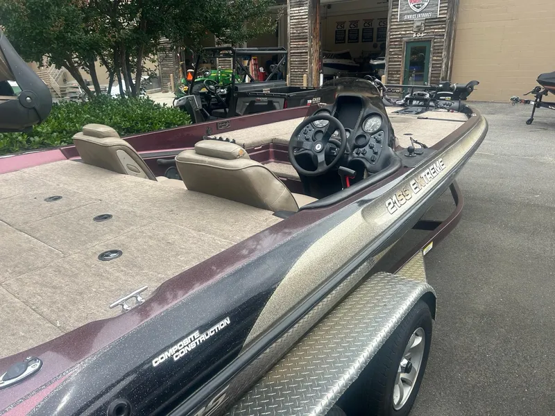 Slide: The Image of 2000 Stratos 21 SS Extreme boat with dual seats and steering console, parked outdoors. - 7