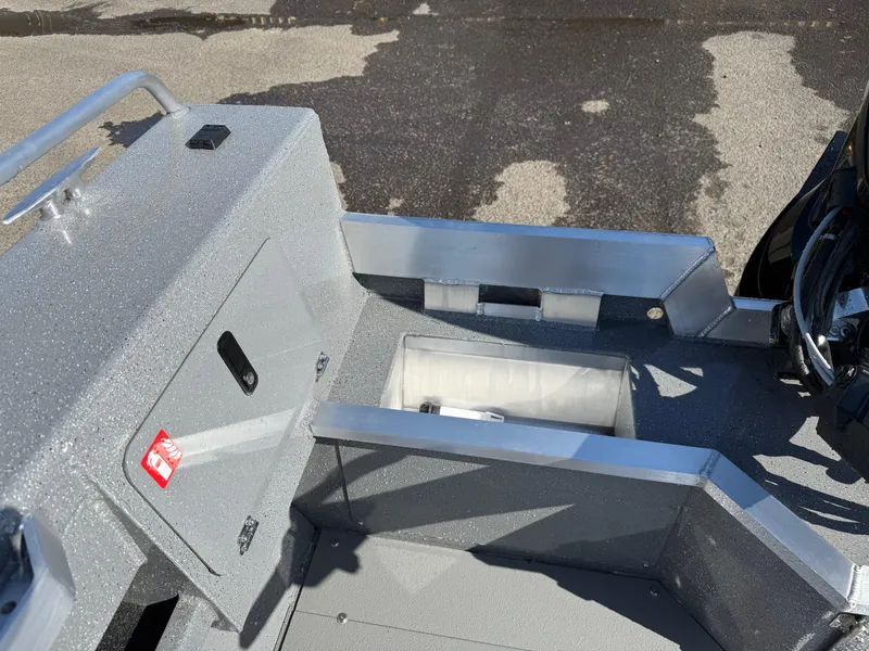 Slide: The Image of 2025 Thunder Jet 209 Rush OT boat interior with storage compartment and metallic finish. - 11