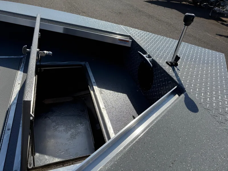 Slide: The Image of 2025 Thunder Jet 209 Rush OT boat storage compartment with open hatch and textured flooring. - 23