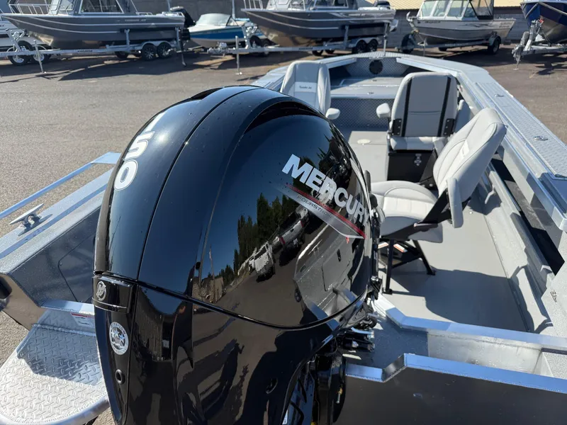 Slide: The Image of 2025 Thunder Jet 209 Rush OT boat with Mercury outboard motor, parked in a marina. - 24