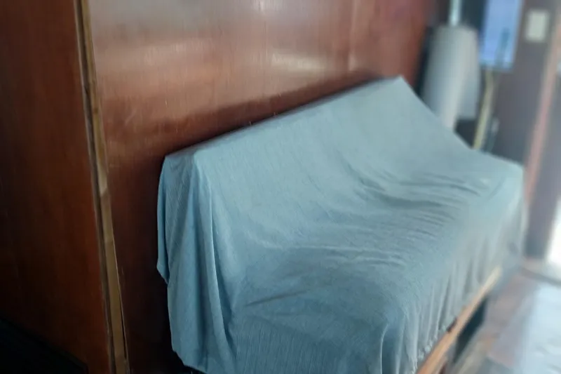 Slide: The Image of Covered seating area inside 1982 Hatteras 61 Motor Yacht with wooden paneling. - 14