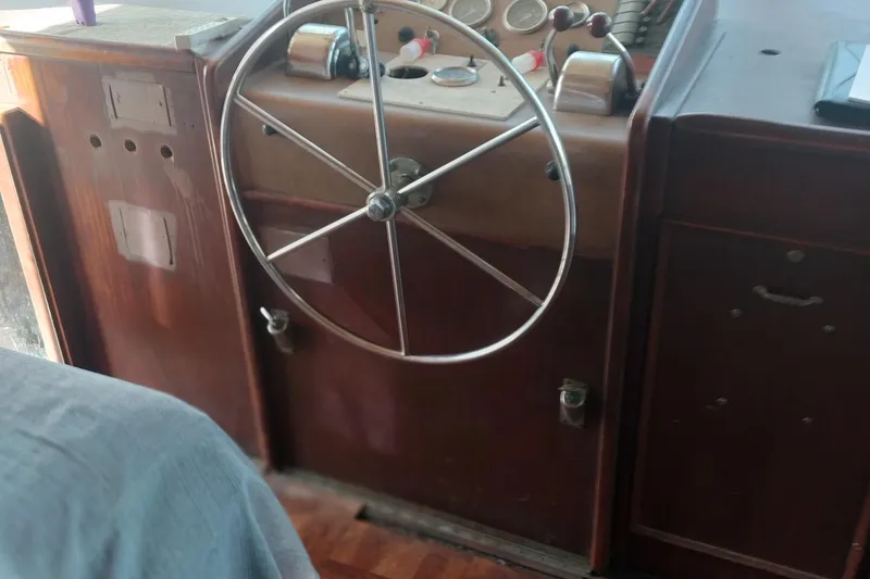 Slide: The Image of 1982 Hatteras 61 Motor Yacht helm with classic wooden dashboard and steering wheel. - 15