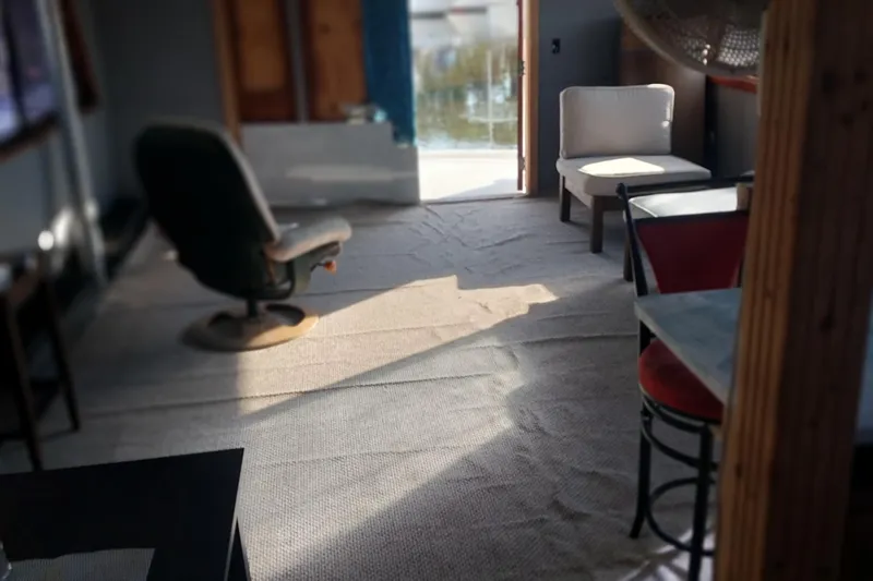 Slide: The Image of Interior of 1982 Hatteras 61 Motor Yacht with chairs and sunlight. - 21