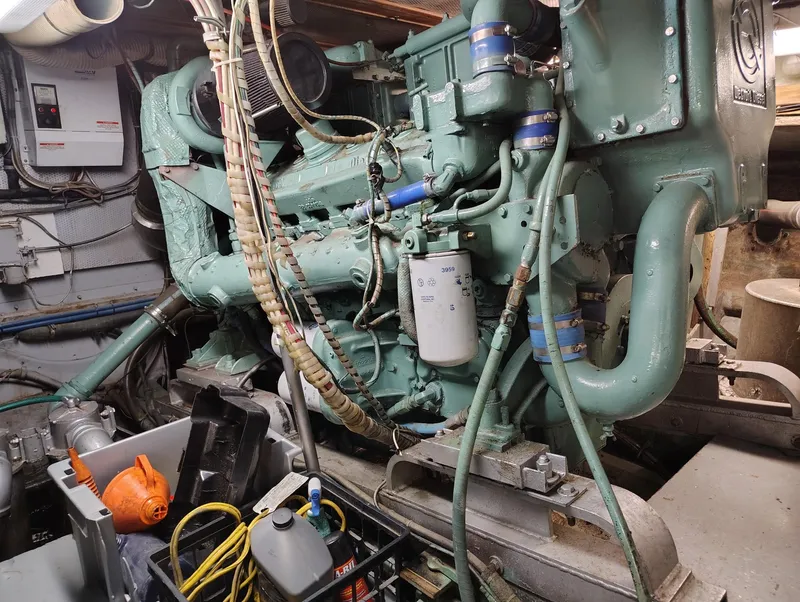 Slide: The Image of Engine room of a 1982 Hatteras 61 Motor Yacht with visible machinery and equipment. - 23
