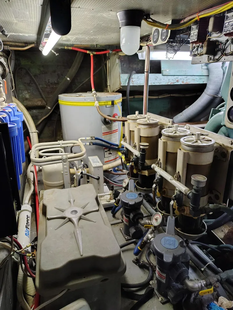 Slide: The Image of Engine room of a 1982 Hatteras 61 Motor Yacht with mechanical components. - 25