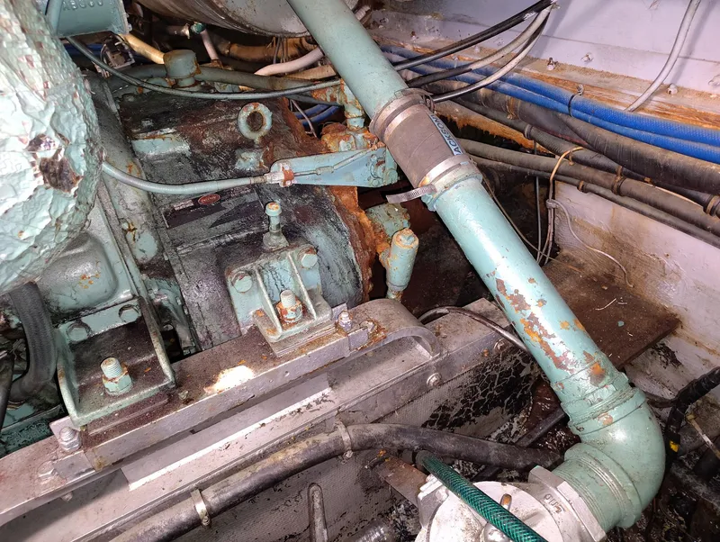 Slide: The Image of Engine room of 1982 Hatteras 61 Motor Yacht with visible pipes and machinery. - 26