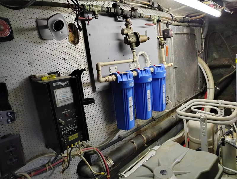 Slide: The Image of Engine room of 1982 Hatteras 61 Motor Yacht with water filtration system and electrical panel. - 27