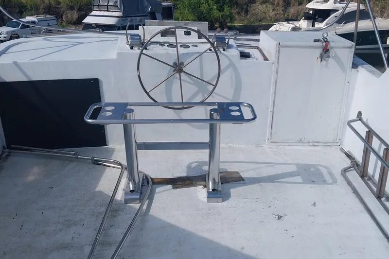 Slide: The Image of 1982 Hatteras 61 Motor Yacht helm with stainless steel wheel and console. - 3