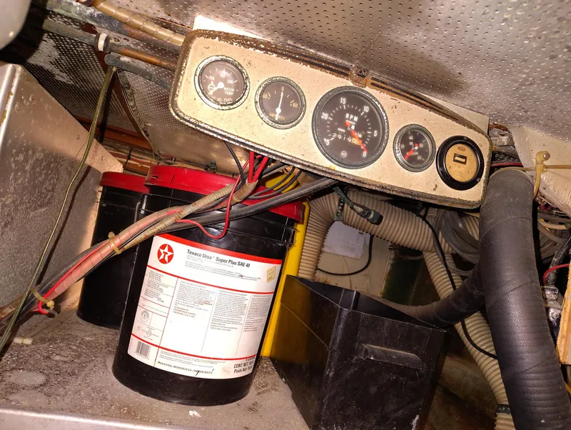 Slide: The Image of Engine room of 1982 Hatteras 61 Motor Yacht with gauges and oil containers. - 32