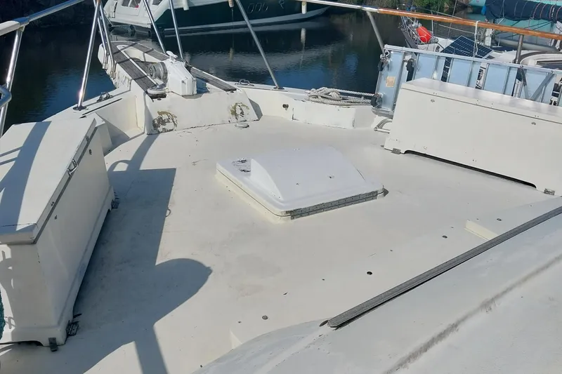 Slide: The Image of 1982 Hatteras 61 Motor Yacht deck with storage compartments and railing. - 7