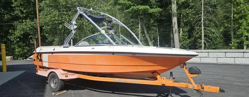 Slide: The Image of 2007 MasterCraft X1 boat on trailer, orange hull, parked outdoors. - 30