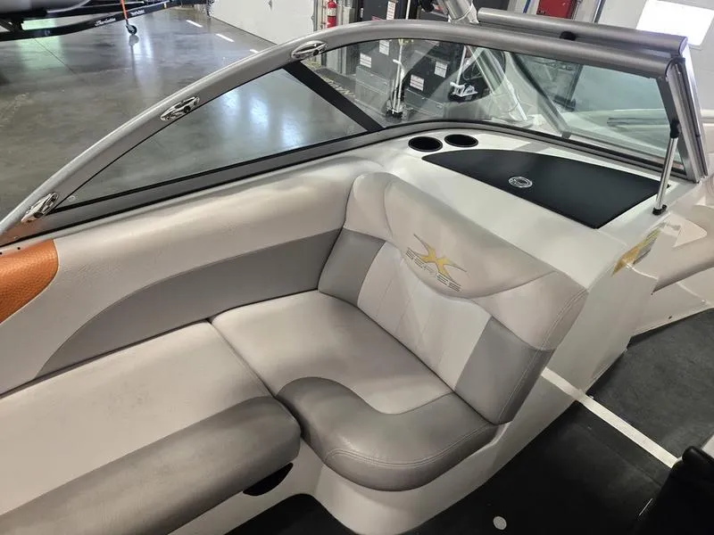 Slide: The Image of 2007 MasterCraft X1 boat interior with gray seating and cup holders. - 31