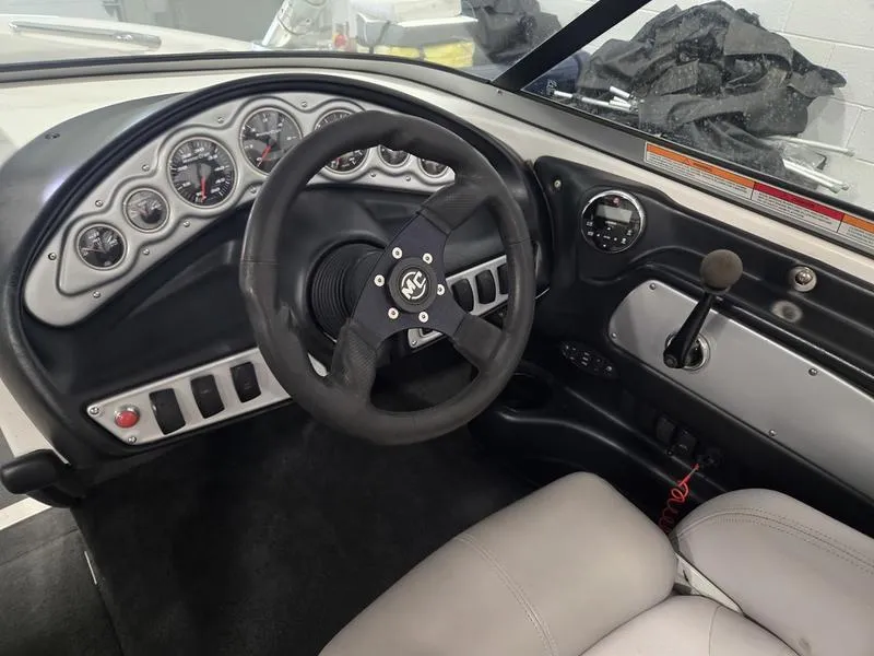 Slide: The Image of 2007 MasterCraft X1 boat dashboard with steering wheel and control panel. - 32