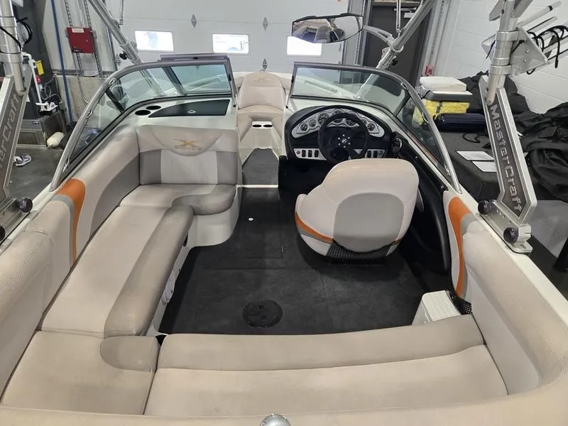 Slide: The Image of 2007 MasterCraft X1 boat interior with beige seating and modern dashboard. - 35