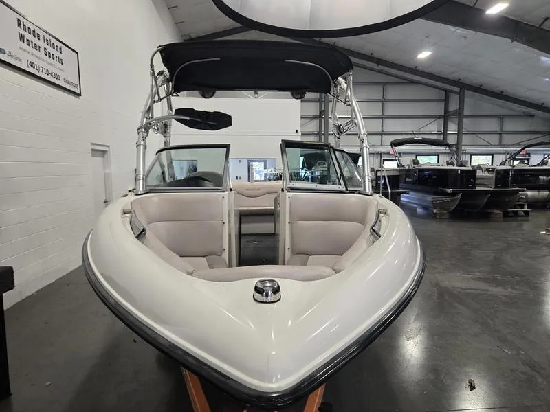 Slide: The Image of 2007 MasterCraft X1 boat in showroom, featuring open bow seating and wakeboard tower. - 36