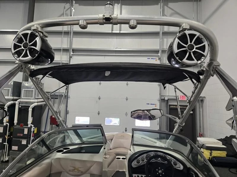 Slide: The Image of 2007 MasterCraft X1 boat interior with speakers and dashboard in a garage setting. - 38