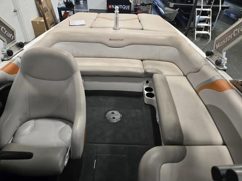 Slide: The Image of 2007 MasterCraft X1 boat interior with beige seating and cup holders. - 40