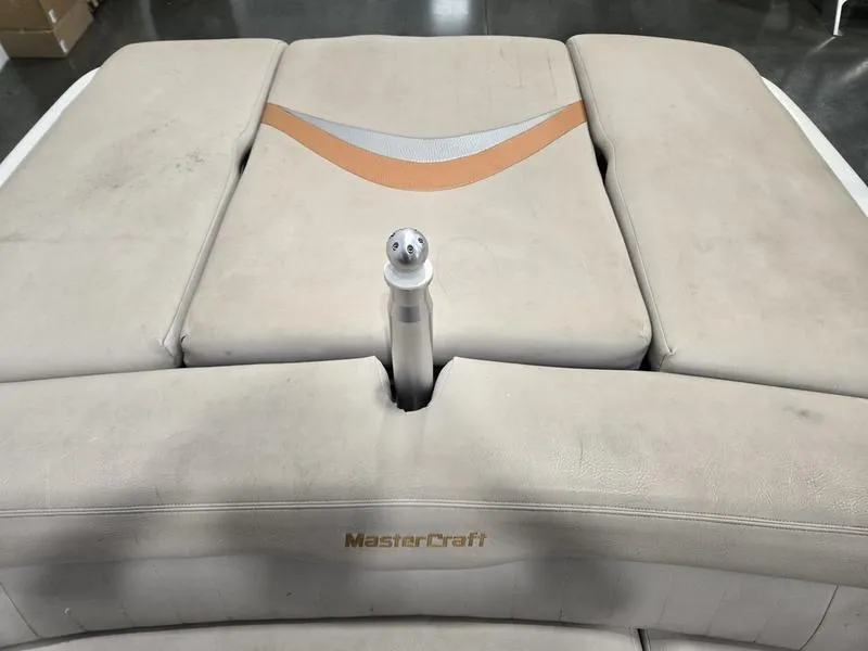 Slide: The Image of 2007 MasterCraft X1 boat interior with beige upholstery and logo. - 42