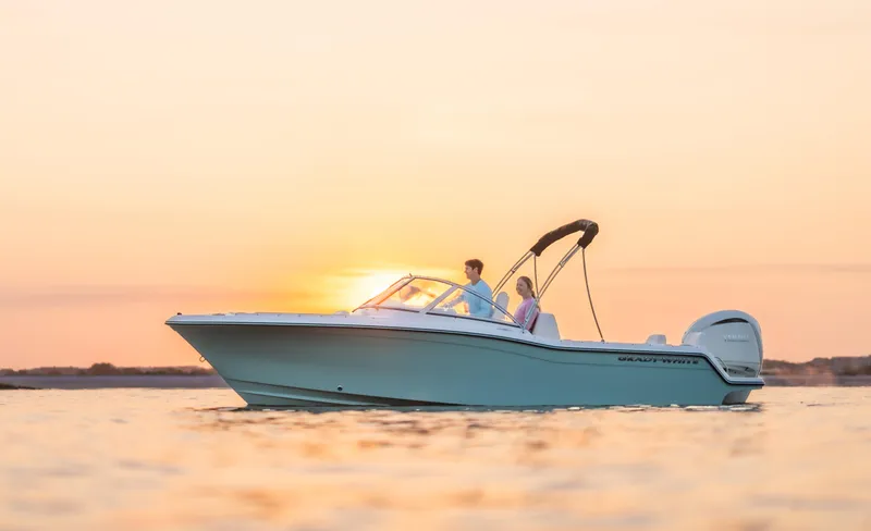 Slide: The Image of 2026 Grady-White 215 Freedom boat cruising at sunset on calm waters. - 18