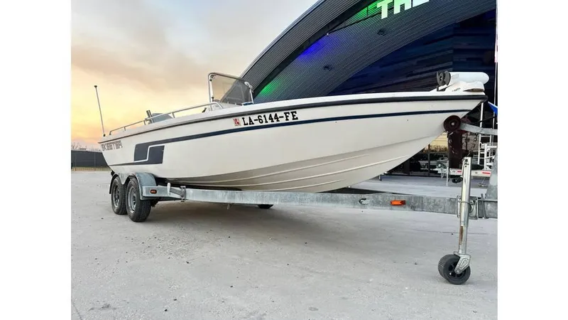 The Image of 2001 Skeeter 2200 ZX boat on trailer, parked outdoors at sunset. - 1