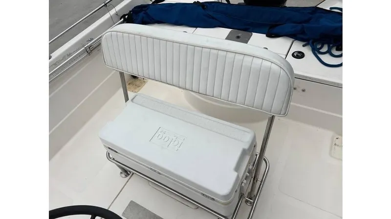 Slide: The Image of 2001 Skeeter 2200 ZX boat interior with white cushioned seating and cooler. - 13