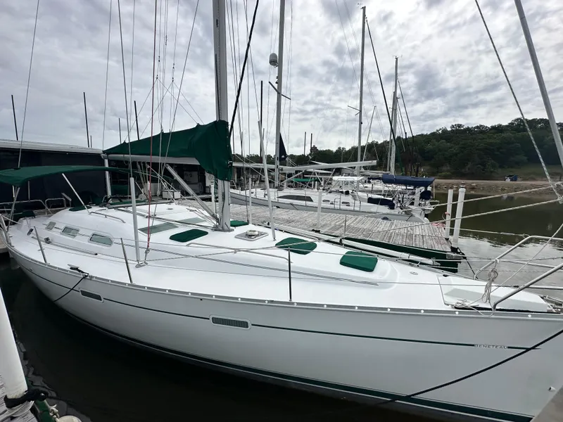 Slide: The Image of 2004 Beneteau 393 sailboat docked at marina under cloudy sky. - 11