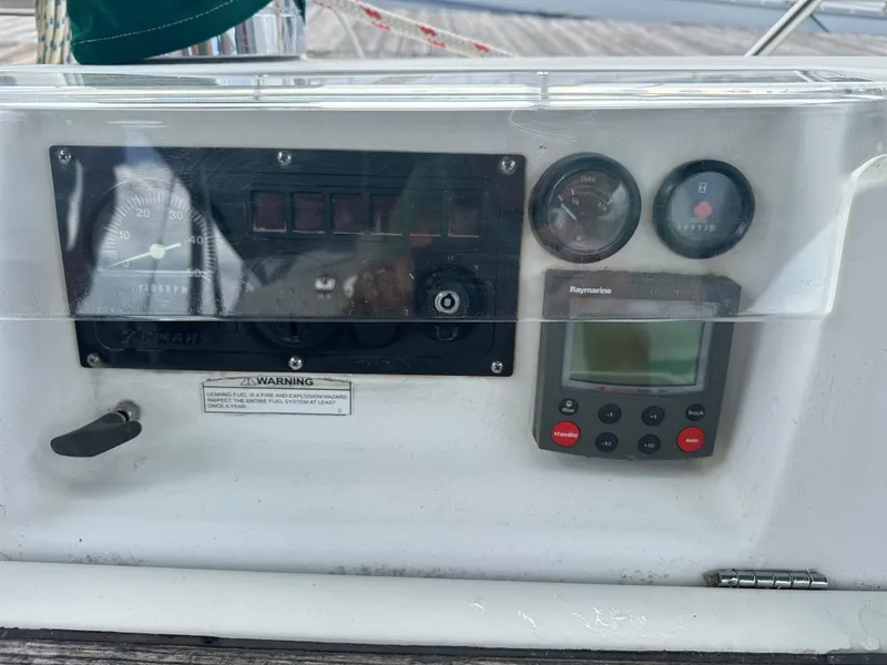 Slide: The Image of Control panel of a 2004 Beneteau 393 sailboat with gauges and Raymarine display. - 16
