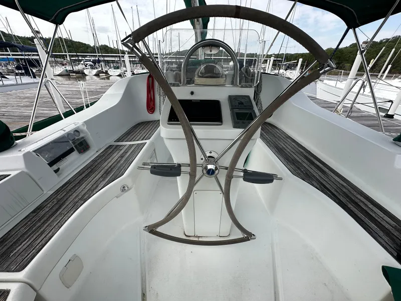 Slide: The Image of Cockpit of 2004 Beneteau 393 sailboat with steering wheel and navigation instruments. - 23