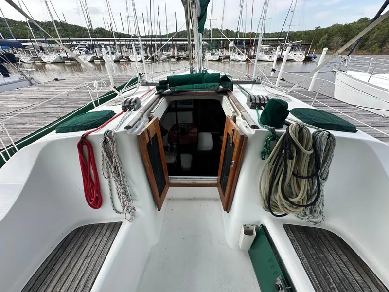Slide: The Image of 2004 Beneteau 393 sailboat cockpit with ropes and open cabin doors at marina. - 26
