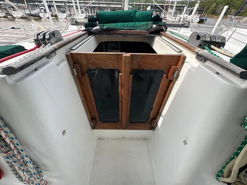 Slide: The Image of 2004 Beneteau 393 sailboat cockpit with wooden hatch doors and ropes. - 27