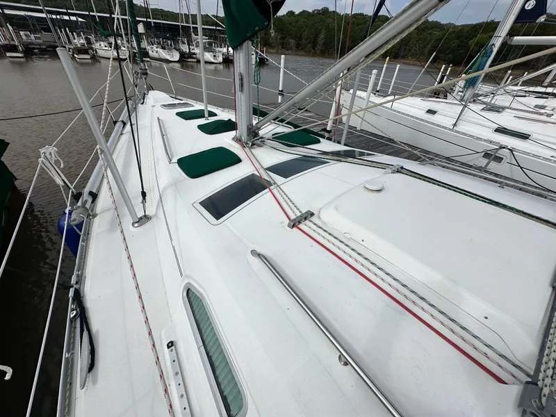 Slide: The Image of 2004 Beneteau 393 sailboat docked, showcasing deck and rigging details. - 28
