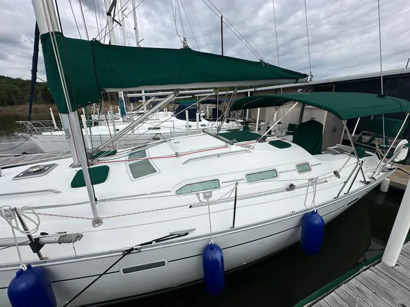Slide: The Image of 2004 Beneteau 393 sailboat docked with green canopy and blue fenders. - 3