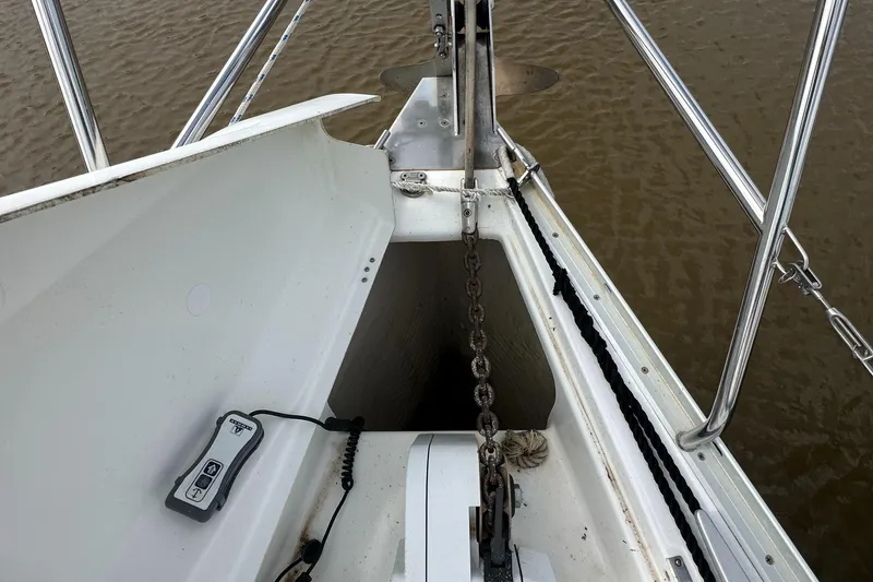 Slide: The Image of Bow of 2004 Beneteau 393 sailboat with anchor chain and remote control. - 30
